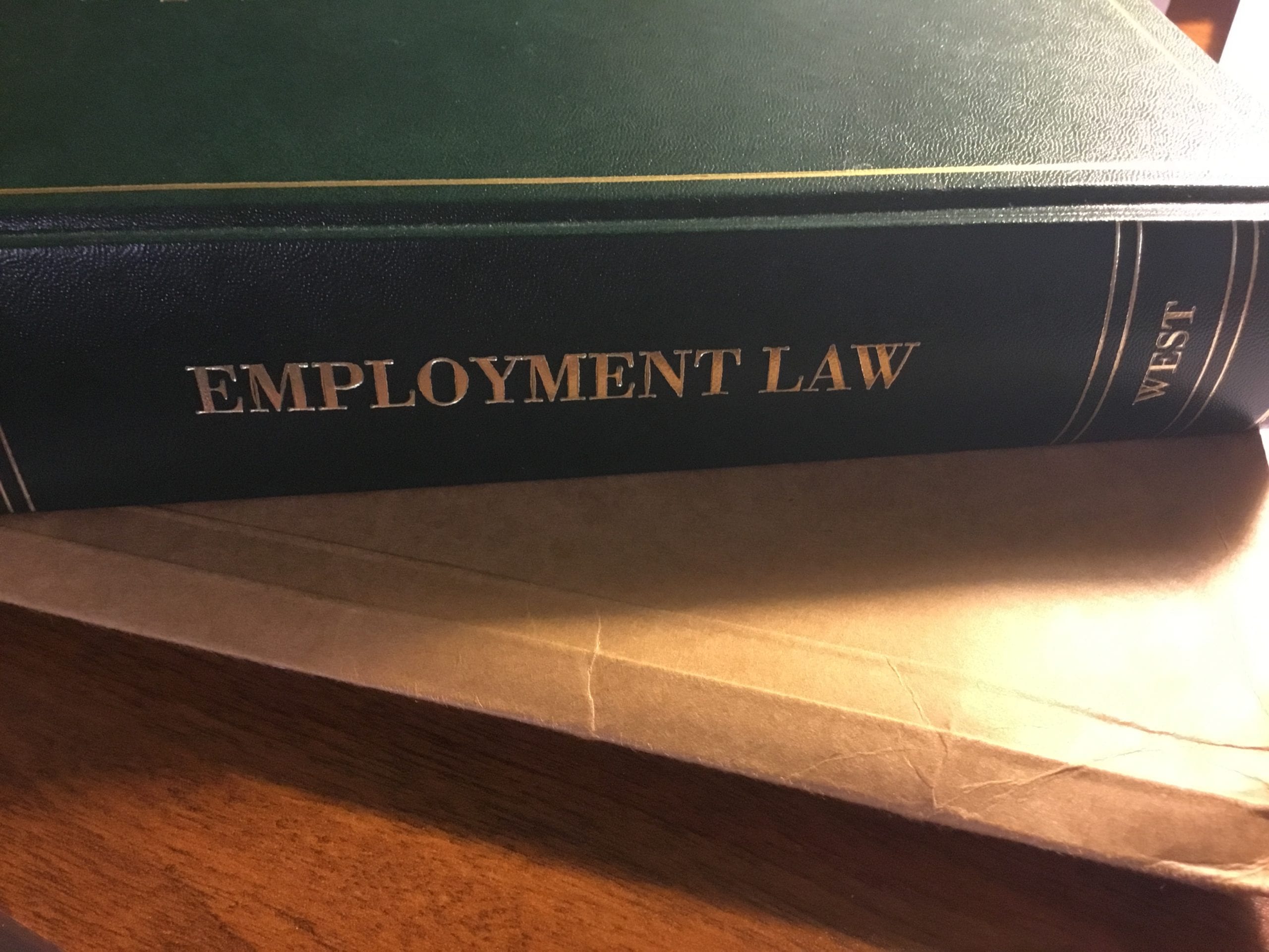 Green Employment Law Book on a desk.