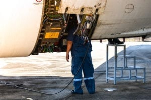 Airline mechanic working on commercial aircraft. 