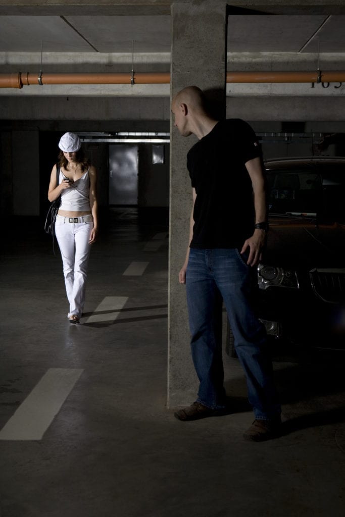 Unsafe premises: criminal about to attack an unsuspecting woman in a parking garage with no security. 